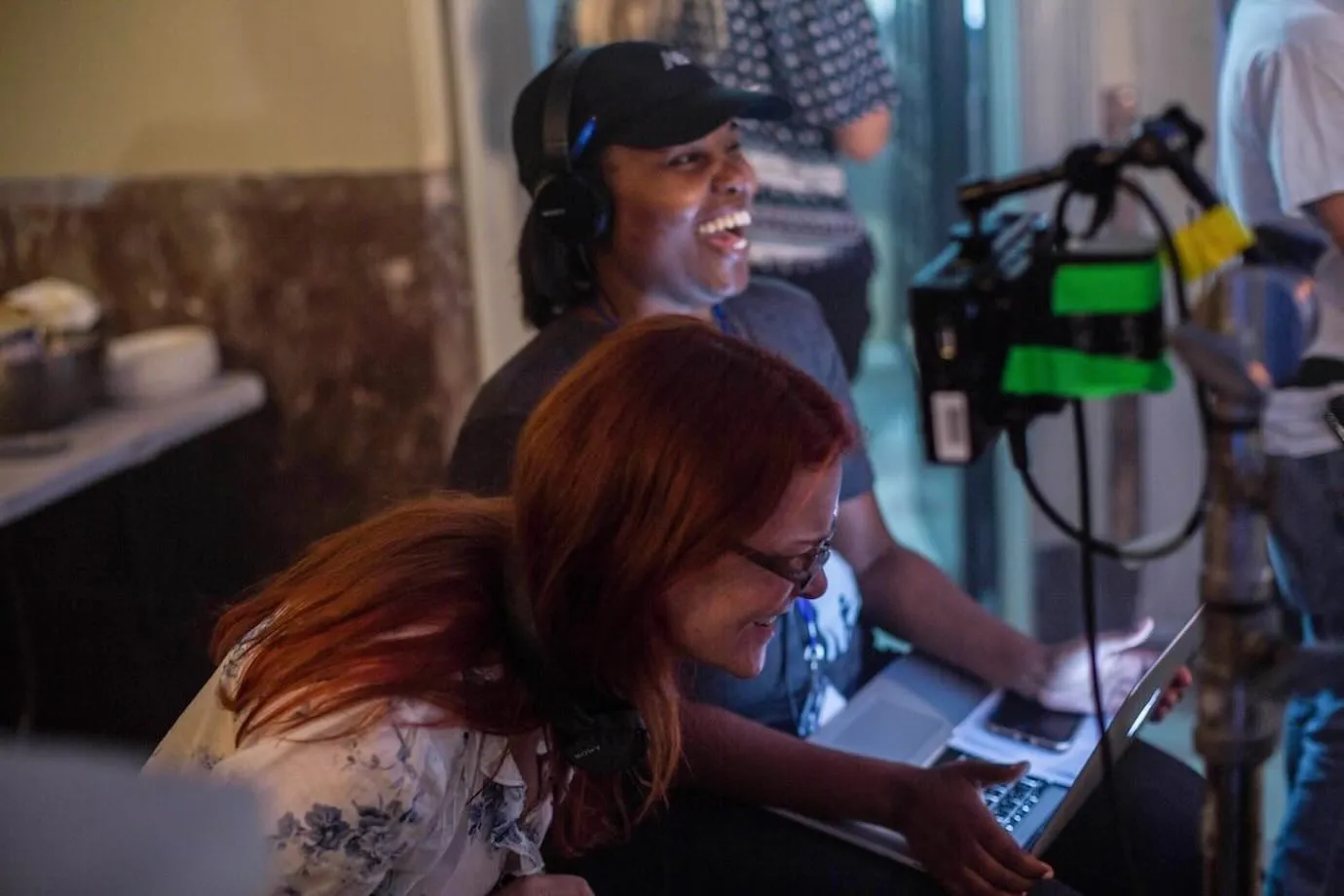 Anne Welles directing on set, laughing with crew