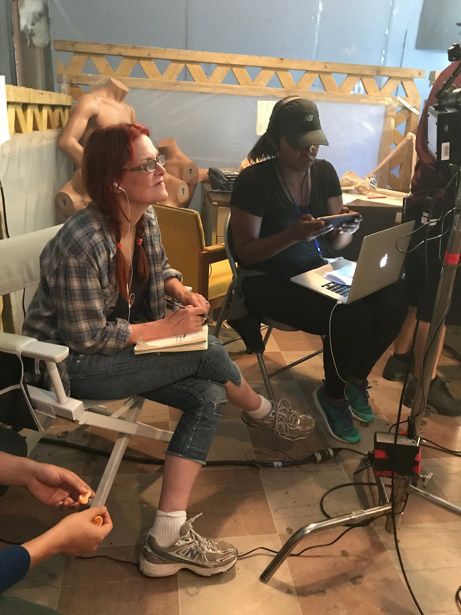 Anne Welles smiling at monitor on set
