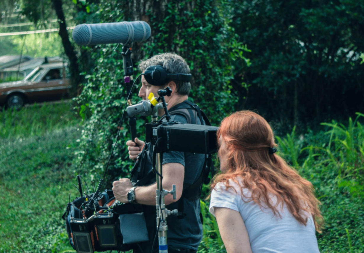 Anne Welles and Jason reviewing footage at the monitor
